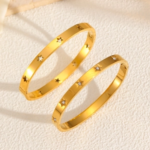 Polished star cutout bangle set in gold finish with micro-inlaid cubic zirconia