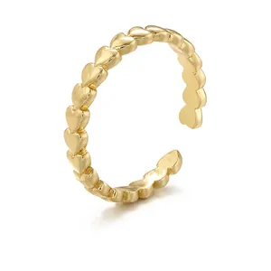 Polished gold brass open ring featuring a row of linked hearts for women