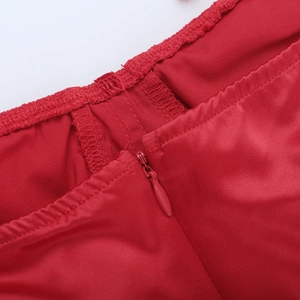 Close-up of invisible zipper and fine stitching on a red satin bodycon dress