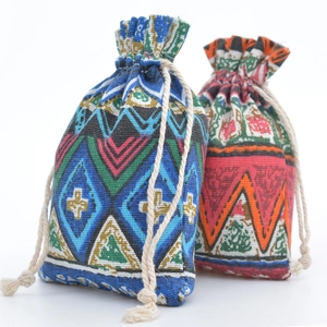 Detail of drawstring cotton pouch featuring ethnic geometric patterns in blue and red