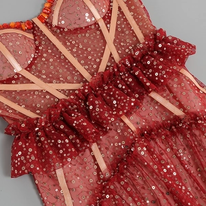 Detailed view of red sequins and intricate tulle mesh craftsmanship on party dress