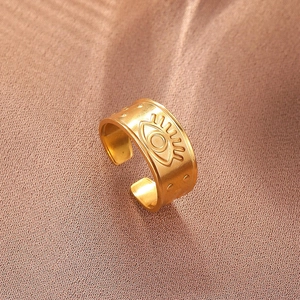 Detailed macro view of gold-plated evil eye ring with matte brushed finish texture