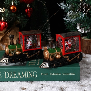 Christmas train snow globe lanterns with Santa and snowman figures on a festive table