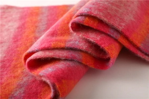 Close-up of pink, orange, and gray striped scarf with soft brushed texture and edge stitching