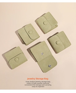 Detail shot of sage green microfiber jewelry pouches showing metal snap button closures