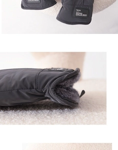 Close-up of the plush fleece lining and detailed stitching of grey winter cycling gloves