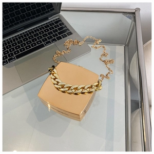 Close-up of a luxury gold metallic square evening clutch bag with chunky chain handle