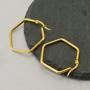 Minimalist geometric hexagon hoop earrings in polished gold finish on dark slate base