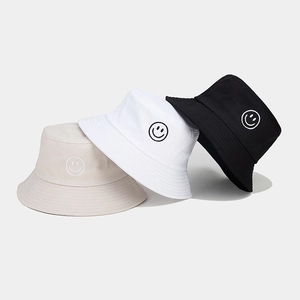Vue détaillée de la broderie smiley sur des bobs en sergé de coton en trois couleurs