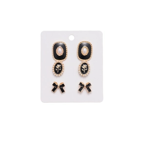 Retro bow and oval black enamel earrings set with pearls and gold flower accents