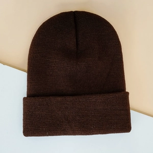 Detailed view of the fine knit texture and wide cuffed brim on a dark brown beanie