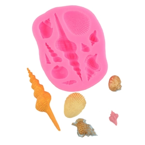 Pink silicone mold for shell shapes with colorful DIY ocean theme fondant examples