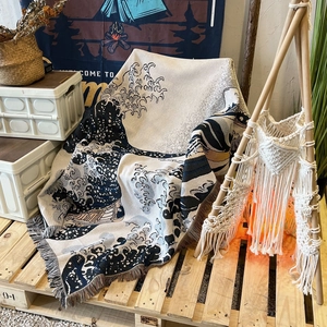 Detail of bohemian jacquard throw blanket with Ukiyo-e waves and tassel edges