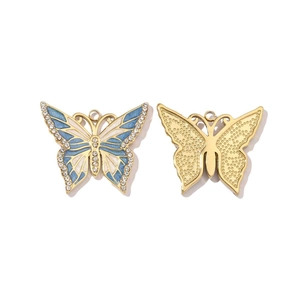 Detail of mirror polished butterfly pendant with blue enamel and sparkling rhinestones