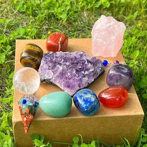 Polished natural healing crystals set with amethyst cluster and gemstone pendulum