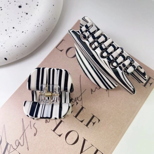 Minimalist black and white striped hair claw clips set with elegant zebra pattern design