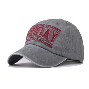 Detail of red Friday embroidery and washed vintage cotton texture on grey baseball cap