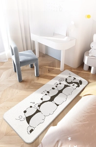 Detail of soft lamb wool bedside rug with cartoon panda pattern on wooden floor