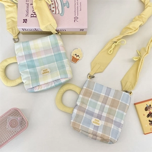 Close-up of cute plaid coffee cup shaped water bottle bags with adjustable straps