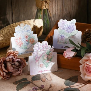 Detail view of 3D floral Mother's Day greeting cards with tulip illustrations on a wooden tray