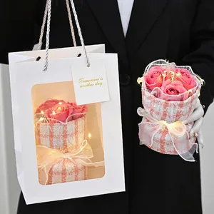 Pink soap rose flower bouquet with LED lights in a stylish tweed wrapping gift box