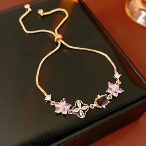 Adjustable gold flower bracelet with purple zircon stones on luxury display box
