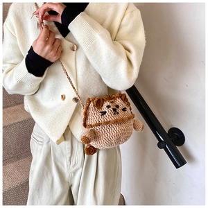 Detail of hand-crocheted lion-shaped drawstring crossbody bag in khaki knit