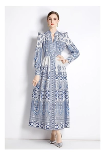 Detailed view of vintage paisley print and waist cinching on the long blue dress