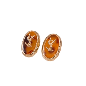 Maillard resin oval earrings with gold frames and amber tortoise shell finish