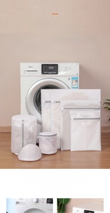 Close-up of durable gray and white mesh laundry bags for delicate clothes protection