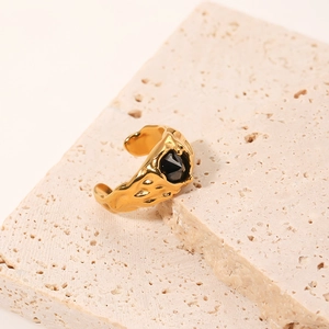 Vintage golden ring with hammered texture and black zircon stone on stone base