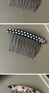 Detailed close-up of acetate hair combs in polka dot and leopard print patterns with metal teeth