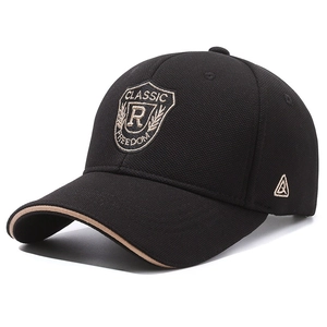 Black cotton baseball cap with shield embroidery and beige brim edge detail