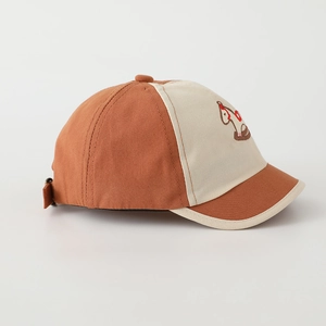Detail of embroidered rocking horse on vintage brown and beige cotton baseball cap