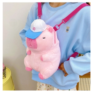 Detailed view of a cute pink capybara plush backpack with blue hat and adjustable straps