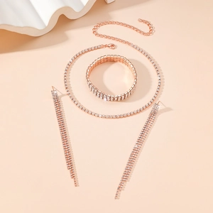 Detailed view of rose gold bridal jewelry set with sparkling rhinestone tassels and necklace