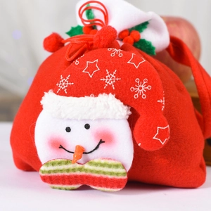 Close-up of red snowman drawstring gift bag with felt texture and fabric bow detail