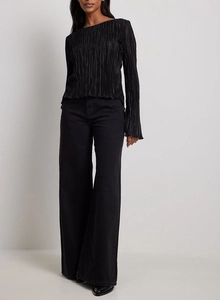 Detailed view of the fine vertical pleats and texture on the black long sleeve blouse