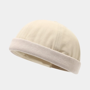 Detail of high-density canvas docker hat showing cream dome stitching and ribbed edge