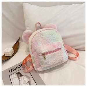 Close-up of tie-dye plush backpack featuring 3D bear ears and gold-tone zipper detailing