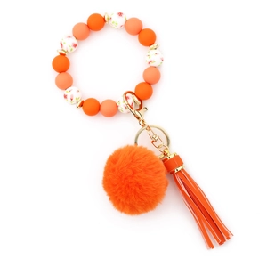 Orange beaded wristlet keychain with fluffy faux fur pompom and floral silicone beads