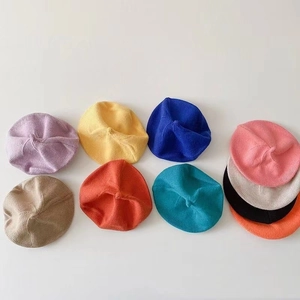 Mise à plat de bérets en tricot pour tout-petits en plusieurs couleurs vives et douces