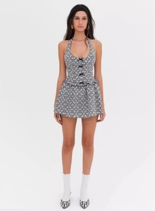 Detail of gingham halter dress featuring a front bow tie and flattering A-line silhouette
