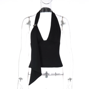 Detail of black halter top featuring metal buckle and asymmetrical pointed hemline
