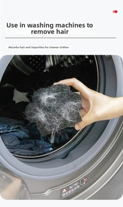 Macro view of sponge pet hair remover catching white lint in a washing machine drum
