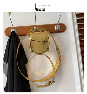 Detail view of metallic gold mini waist bag with adjustable strap and square flap design