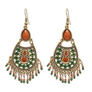 Vintage bohemian drop earrings with colorful beads and metallic tassels on white background