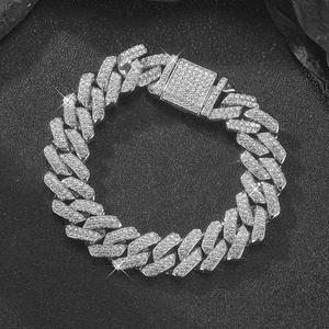 Macro detail of 14mm silver Cuban chain with shimmering diamonds and box clasp lock