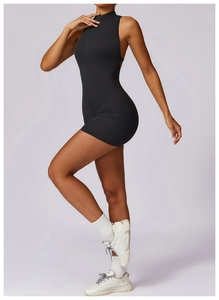 Detail of high-stretch black yoga jumpsuit with front zipper closure and slim fit design