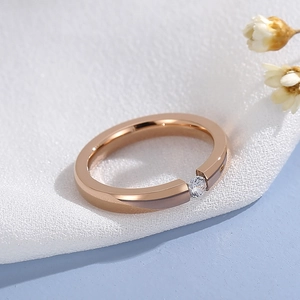 Close-up of rose gold stainless steel ring featuring a sparkling zircon solitaire stone